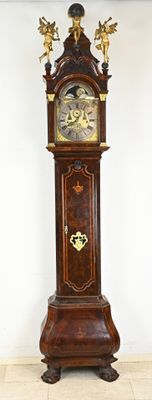 a grandfather clock that is standing in the corner of the room