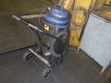 a picture of a vacuum on a cart in a garage