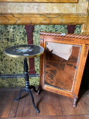a small table with a mirror on it next to a mirror
