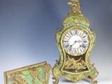 a small clock sitting next to a smaller clock