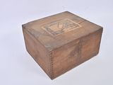 a small wooden box with a stamp on it
