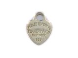 an image of a silver heart shaped tag with the words new york on it
