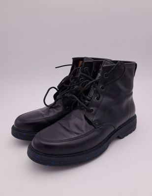 a pair of black leather boots on a white background