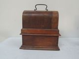 a small wooden box with a handle on top of it