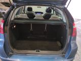 the back of a blue car with its trunk open in a parking lot