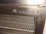 a black oven with the door open in a kitchen