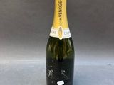 a bottle of champagne sitting on top of a table