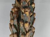 a close up of a wooden sculpture of a pine cone