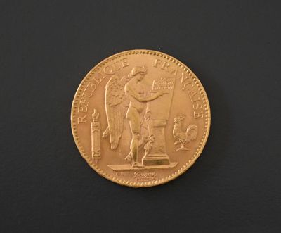 a close up of a gold coin on a black surface
