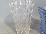 two glass vases sitting next to each other on a table