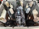 many bottles of wine sitting in a metal container
