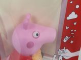 pep the pig in a red shirt with a yellow star on it ' s chest