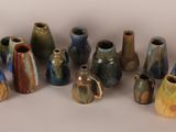a lot of vases that are sitting on a table