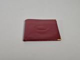 a small red leather wallet with a gold zipper