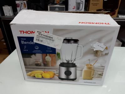 a box that has a blender in it on a table