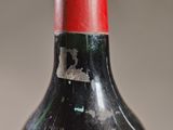 a bottle of wine that has been left on the table