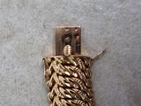 a gold chain that is attached to a lighter