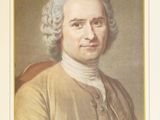 portrait of a man with white hair and a brown jacket
