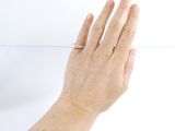 a woman ' s hand with a ring on it