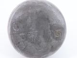 grey vase with a hole in the middle of it on a white surface