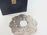 a silver plate on a table next to a black box