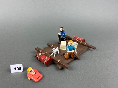 une figurine représentant un homme assis sur un radeau avec un chien