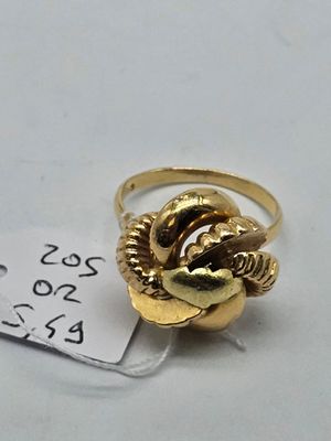 a gold ring with a snake on it and a price tag