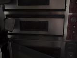 three ovens stacked on top of each other in a kitchen