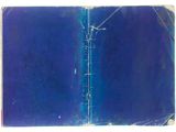 an old book with a blue cover sitting on top of a white surface