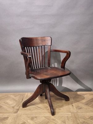 a wooden chair that is sitting on a wooden floor