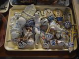a tray full of ceramic figurines on a table