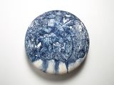 blue and white stone with a tree on it on a white surface