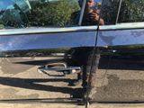 a man taking a picture of himself in the reflection of a car door