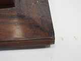 a close up of a wooden frame on a table