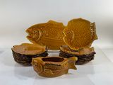 five pieces of pottery that are sitting on a table