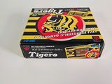 the box of tiger ' s cigarettes is sitting on a white surface