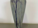 a blue and white vase sitting on a table
