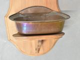 a wooden shelf with a pot and pan on it