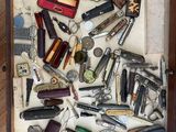 many different types of tools in a drawer on the floor