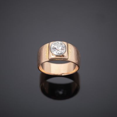 a close up of a gold ring with a diamond on it