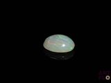 an image of a white oplite in the dark