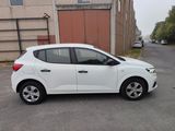 a small white car parked on the side of the road