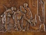 a bronze plaque of a man and a woman on a horse