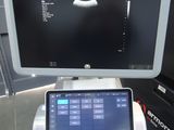 a laptop computer sitting on top of a table next to a monitor