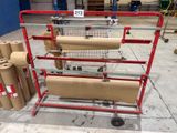 several rolls of brown paper are on a cart in a warehouse