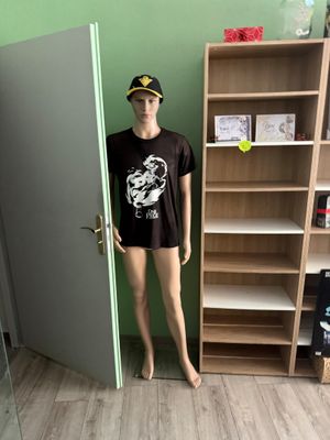 a male mannequin standing in front of a door