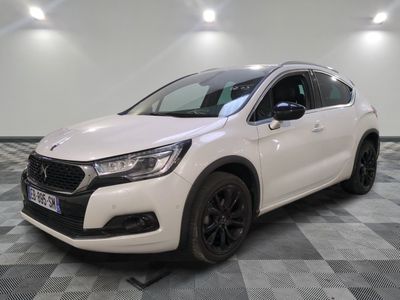 a white car parked on a checkered floor in a garage
