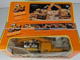 a box with a toy construction vehicle inside of it