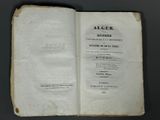 an open book with a black and white image of a man ' s face