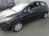 a picture of a small black car parked in a parking lot